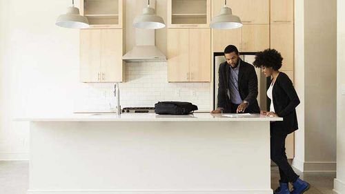 Realtor reviewing costs associated with buying a home with the buyer.